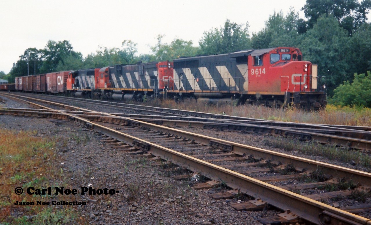 Back in September 1993 CN completed a large-scale bridge replacement west of Paris on the Dundas Subdivision. This resulted in CN rerouting trains not only on their Guelph Subdivision, but also detouring across Canadian Pacific’s Galt Subdivision for several days. In the west, the trains would begin their journey to the Galt Subdivision through the interchange track at Woodstock then onto the CP St. Thomas Subdivision for a short stretch before reaching the Galt mainline. CN 380 is viewed waiting to proceed on this route with 9614, 2038 and 9664 on September 15, 1993.