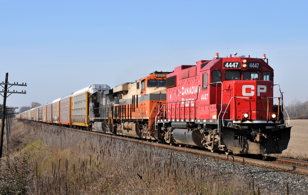 244 slowly moves through Thamesford, ON now with CP 4447, NS 8105, NS 9574, and 67 racks for Wolverton