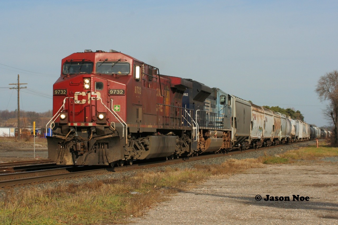 CP 241 with 9732 and UP 1982 (the MoPac heritage unit) rolls through Ayr, Ontario on the Galt Subdivision with work ahead at Wolverton yard during a sunny November afternoon.