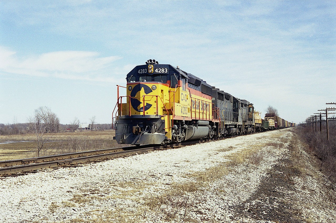 Beautiful Sunday afternoon; I have marked in my notes 1335 hrs as the time I shot this westbound on the second day of April 1978 at Sunset Drive, the last crossing west of Fort Erie before the QEW. C&O 4283,3521 and 3023(GP30)make up the power, with 37 cars and caboose C&O 3525. This track is long gone.  On the extreme right one can see the pole line for CN Stamford Sub.