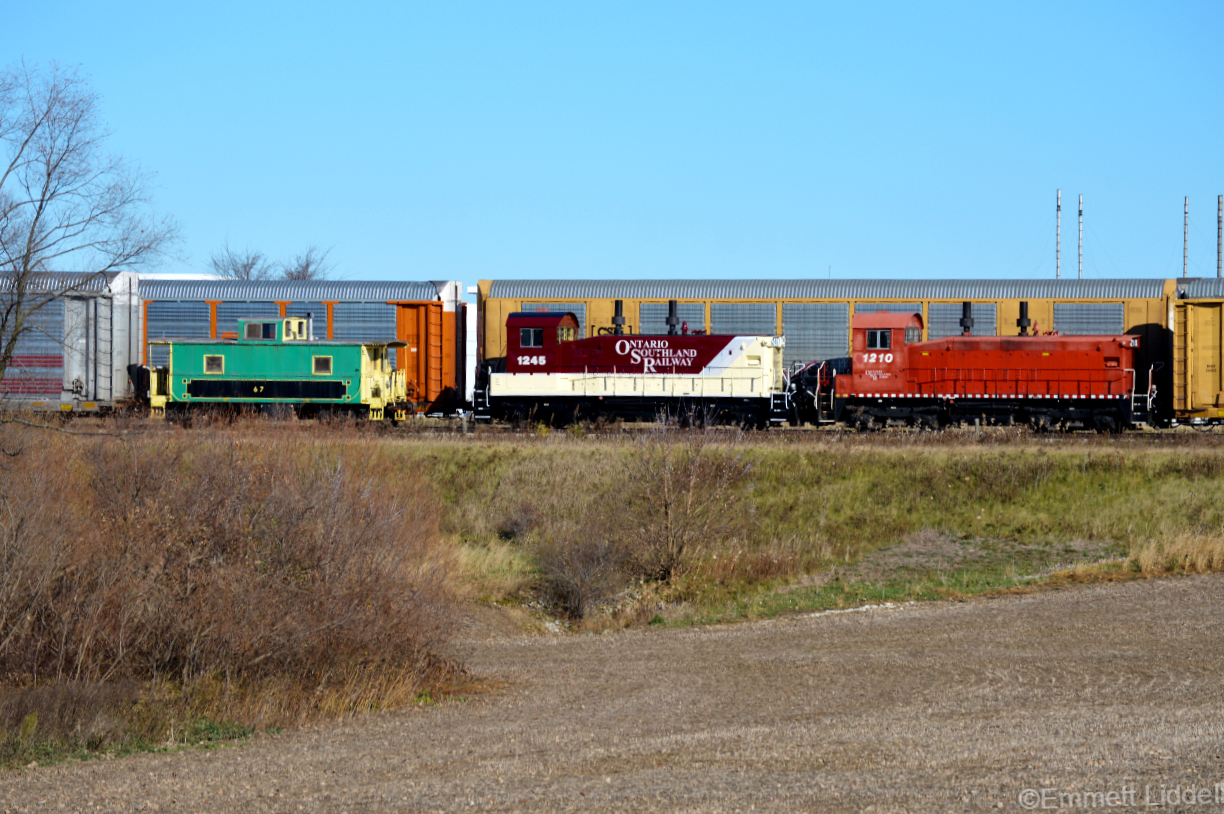 The Ontario Southland Cami job is shoving some autoracks into the Cami plant passing the Ex Port Stanley Railway van 67 with the brand new repaint on 1245 and the cp red 1210. 67 is now in service as a shoving platform for the Cami jobs when they go to beachville to interchange with Canadian National.