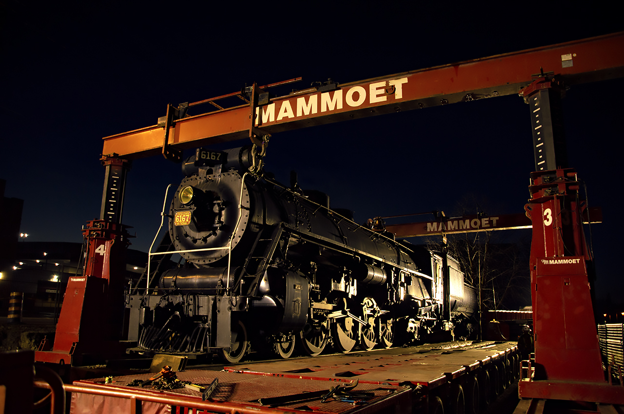 Home Sweet Home.  The cleanup begins after a long day for 80 year old CNR 6167, now at it's new site in Guelph's John Galt Park near the River Run Centre and Guelph Junction Railway.  The 683,000 pound locomotive made the trip from it's previous site earlier today with the engine and tender travelling on separate belt pack operated floats from Mammoet.  The full site will be completed early in the new year, with work completed by Greenspace Groups.   The locomotive now sits on the former site of Guelph's CPR yard; originally the site of Guelph's first building, the Priory, which would later become the CPR station in 1887 after completion of the Campellville-Guelph portion of the GJR.Taken onsite in all required PPE with permission.  Special thanks to Greenspace Group, Mammoet, and Metrolinx for allowing today's photo ops.