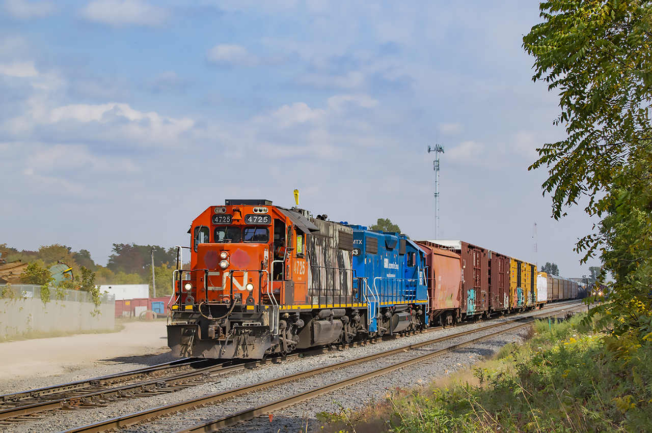 CN L568 pulls west down the siding at Kitchener to double onto it's train waiting a few tracks over and head for Stratford.  After departing west, CN X568, the OSR equipment move (headlight at right) will pull ahead to the crossover and shove back into the yard to end the crew's slow trip from Guelph.