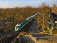 Low November sun brightens the day as train 3806 runs through the heart of Guelph.  Waterloo Avenue can be seen below at left.<br><br>One of the oldest roads in Guelph, this Waterloo Avenue was once <a href=https://s3.amazonaws.com/pastperfectonline/images/museum_51/056/1986191.jpg>level with the GTR line,</a> and grade crossings (Wilson and Norfolk Streets) existed here.  Grade separation came in 1911, coinciding with the construction of <a href=http://www.railpictures.ca/?attachment_id=29452>Guelph's new station,</a> and coming after lengthy disagreements between the City of Guelph and the railway, including a lawsuit of public nuisance (Guelph Mercury, November 11, 1908) for lack of a new station, and three grade crossings in the downtown core (the third being Wyndham - then Huskisson - Street).  A later grade separation in 1965 would create the underpass pictured above for Norfolk Street to continue through.<br><br>As seen in the linked image above, rails once ran down the centre of Waterloo Avenue, then called Market Street for a portion.  This was one of the first lines of the Guelph Railway Company, later <a href=https://s3.amazonaws.com/pastperfectonline/images/museum_51/089/2009321303.jpg>Guelph Radial Railway,</a> founded by brewmaster George Sleeman of <a href=https://s3.amazonaws.com/pastperfectonline/images/museum_51/042/1981672.jpg>the Silvercreek Brewery.</a>  This line would also host the railway's <a href=https://s3.amazonaws.com/pastperfectonline/images/museum_51/197/2009326027.jpg>car barns at 371 Waterloo Ave.</a> which still stand as apartments today.<br><br>A complete <a href=https://guelph.pastperfectonline.com/archive/6FE83B72-77CD-4C36-98F1-804544600020>Inventory of Shop Tools & Car Equipment of Guelph Radial Railway, December 1920</a> was recently added to the online archives of the Guelph Civic Museum, providing great technical detail for the roster.