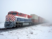 CN 183 pops out of the ice fog just west of Semans Saskatchewan with BC Rail heritage unit 3115 on the point. 