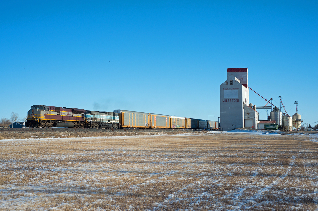 CP 7012 and CEFX 1002 are doing every bit of track speed through Milestone Saskatchewan.
