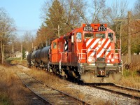 Just like old times.  Looking just like the CP St. Thomas Sub. before Ontario Southland, the OSR Woodstock Job passes by backyards in Beachville, ON in the last light of the day.  It's pretty depressing how early the sun sets this time of year, the photo was taken at 4:10 p.m.!  Today's train had two CP-painted geeps and four tank cars that they had just picked up from CP T69 in Woodstock.    CP T69 went in to emergency around Zorra and it sounded like they had to make repairs to a car, so the OSR crew had an extra long break in the Woodstock station waiting for their cars.   