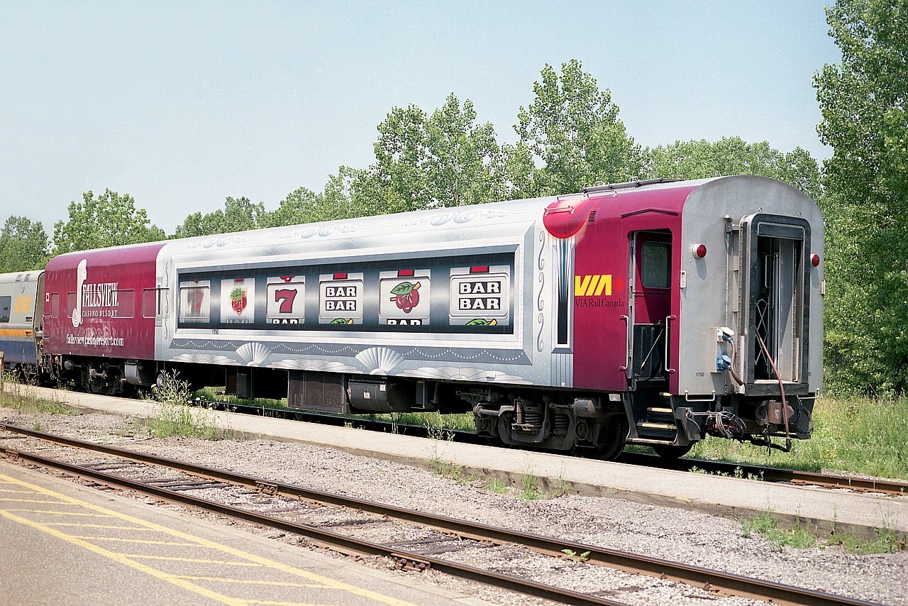 Posting this because I am curious about it. I got a few photos of this car on train #93 (Toronto to Niagara Falls) in the summer of 2006.
I know it is the "glenfraser" lounge car #1750. Understand it had a casino in it!! Came to VIA from BC Rail in 2002 and that they 'winterized' it in 2005.
Nice rolling billboard for VIA.  But I am wondering; when and for how long was this wrap applied? I seem to recall it only that one summer.
THANKS!!