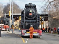 Well the big move of steam locomotive CN 6167 is upon us. With the expansion of the GO facilities at the station, it was either scrap, sell or relocate this consist that has been a fixture in Guelph for many years so the decision was made to move it to a new location along the Speed River. With the tender already being slowly backed in to its new location by the Mammout transport truck in the background, CN 6167 sits on the remotely controlled trailer at the stop lights at Macdonell Street awaiting its turn to be fitted in to its new home.  