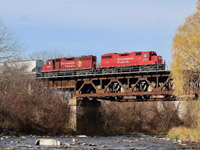 Crossing the river wild. The pungent smell of rotting trout lingers heavy in the air thanks to countless decaying fish along the shoreline of the Credit River. The seagulls definitely don't mind the easy meal though. Overhead CP train T14 with one of CP's youngest and oldest GP38 offerings rattles the old steel bridge as they head back to West Toronto with a stop to switch the CANPA on the way. Trailing GP38AC 3004 has spent most of its life out in western Canada with much of its time spent working the line on Vancouver Island. It even received CP's special E&N green paint for a period. These days its mechanical issues find it coated in oil and never far from Toronto yard in case problems arise.