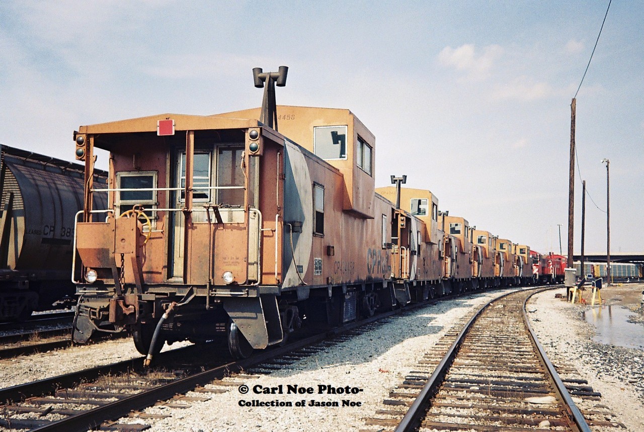 Six active CP cabooses are seen being moved by a pair of SW1200RS's in the railway's Toronto Yard during spring 1994.