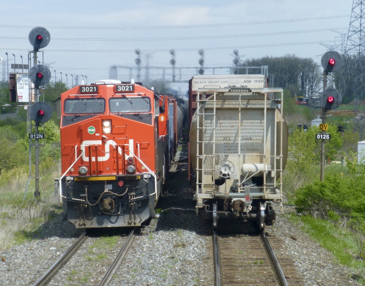 One of my most favourite shots! I know how lucky I have been to live my boyhood dream of being a locomotive engineer. I was blessed to have the biggest train layout to operate.
For me this shot captures the sights, sounds and smell of railroading at its best.
3021 departing Mac Yrd on the Halton outbound track while I follow an eastbound up to Jane St as it enters Mac Yrd on the Halton inbound . My train will wait for a better signal to enter the yard. I would hang up my throttle about a year after I took this shot. Not a day goes by that I don't miss being an engineer.
