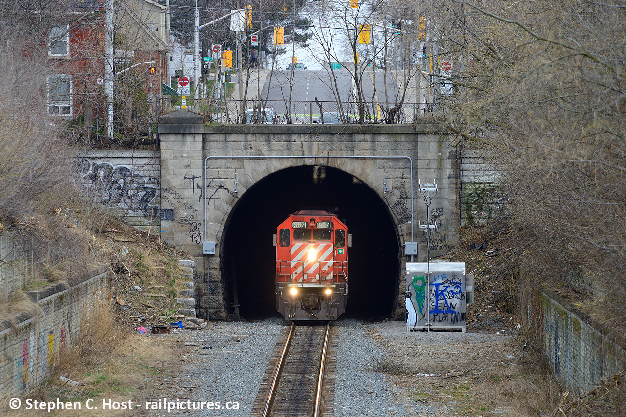 Emerging from the depths of Hamilton's underbelly, SD40-2 5871 with a work train in tow peeks out from the north side of the Hunter St Tunnel. Built in 1895 when the TH&B was permitted to build a line into downtown Hamilton, other than single tracking the once double track CTC mainline not much has changed from this side of the tunnel, aside from the graffiti, litter and other surly things you may find if going for a wander in the grass - here's a hint, don't.