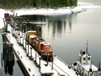 Nelson to Nakusp wayfreight sits at the Rosebery Slip after a 30 mile barge and tug(Iris G) ride on Slocan Lake the previous day. An overnight snow has covered the scene before a crew from Nelson will unload the barge and continue the trip up the isolated branch to Nakusp on the Columbia River.