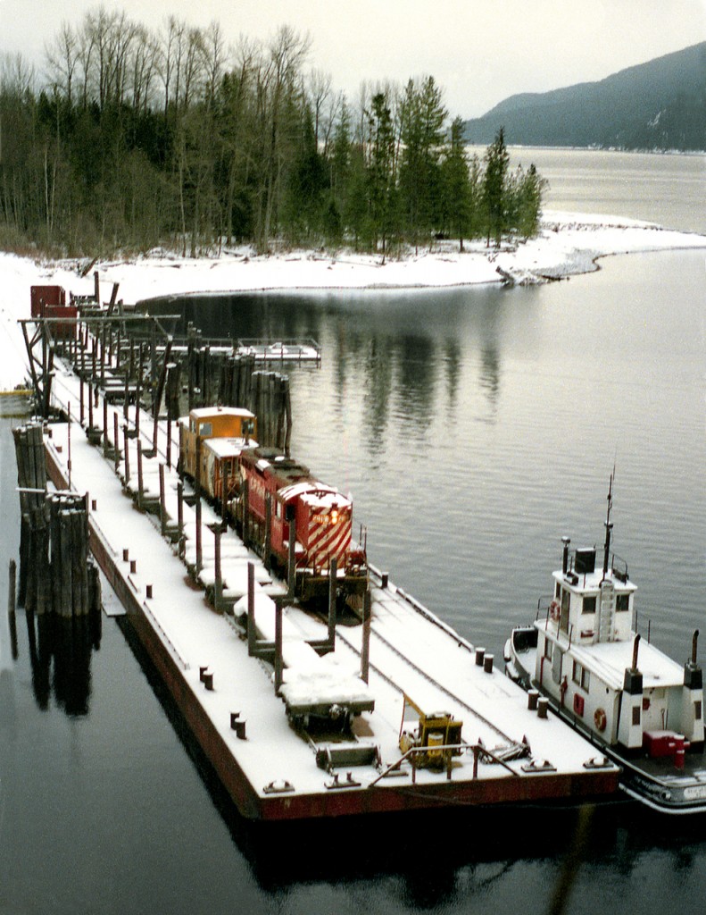 Nelson to Nakusp wayfreight sits at the Rosebery Slip after a 30 mile barge and tug(Iris G) ride on Slocan Lake the previous day. An overnight snow has covered the scene before a crew from Nelson will unload the barge and continue the trip up the isolated branch to Nakusp on the Columbia River.