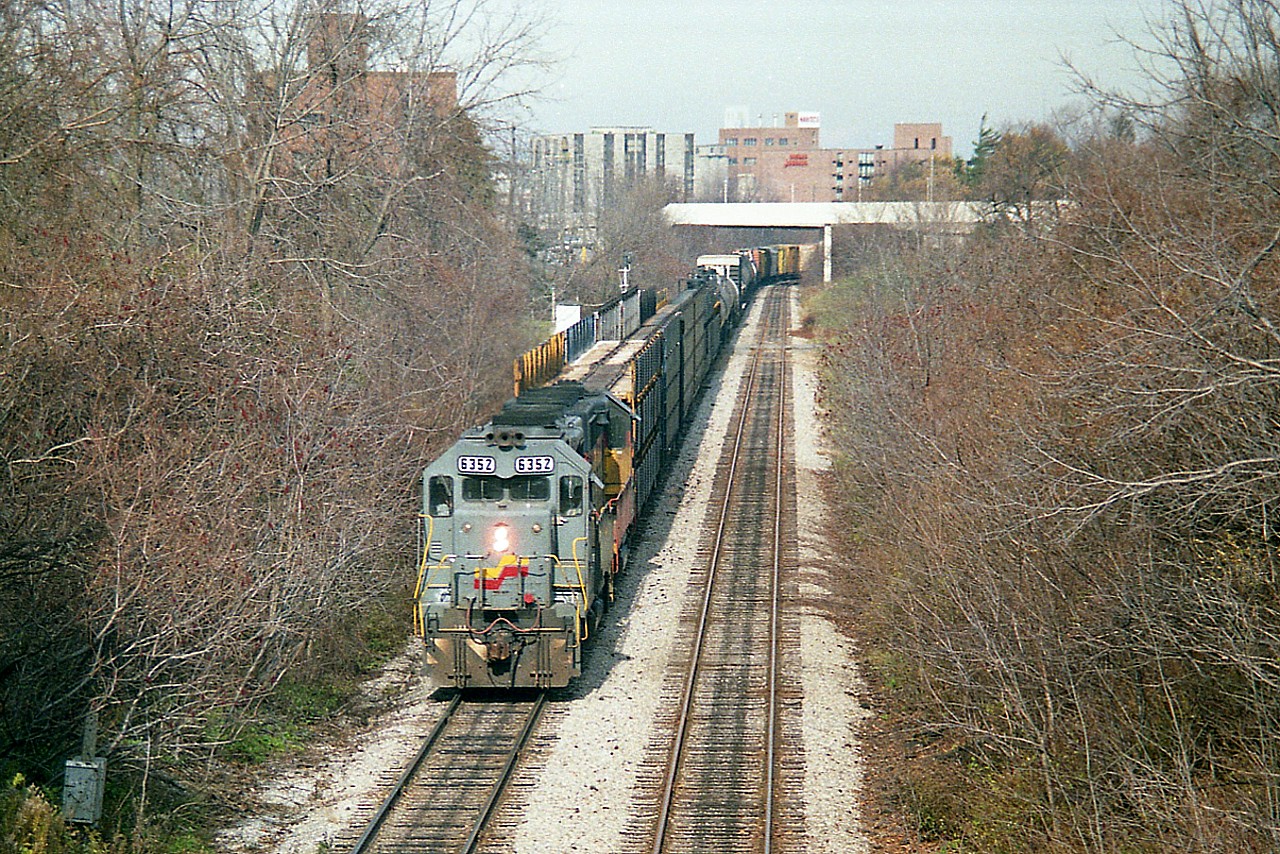 CSX 6352 and 6246 have just cleared thru Clifton Hill area on their trek westward in this image shot from near the base of one of the city's towers(Skylon). It was a treat to see Seaboard paint still adorning units which  were all part of the Chessie System family...and since 1980 known as the CSX.