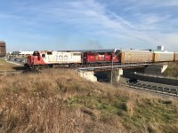 CP T97 with SOO 4410 and 3118 are sorting auto racks for Toyota's Cambridge Assembly plant as they pass over Maple Grove Road in Cambridge, Ontario on the Waterloo Subdivision. 