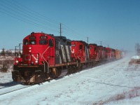 CN 4118, CN 4377, CN 4376(?), CN 4107, CN 9305, and CN 9310 kick up some powder on an all Zebra stripe GMD consist #421, rolling west through the outskirts of Guelph on the Guelph Sub.