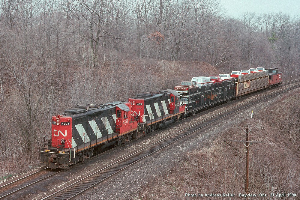 CN 4371 - CN 4105 head toward Hamilton through Bayview with two open autoracks loaded with Ford products from Oakville. CN 4371 would go on to be rebuilt as 7050 in 1992, and retired in July of 2000