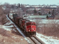 CN GP40-2L(W) 9553 leads four GP9's with some dimensional loads up at the head end of train 421, on the approach to Guelph, Ontario on March 3rd 1990 as photographed from Victoria Road.
