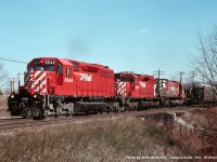 Canadian Pacific GMD SD40's 5544,  5551, and MLW M636 4706, slug a westbound up the grade east of Guelph Junction, about to cross Canyon Road. The lead unit sports the new "non multi" action red scheme, as the multimark logo had been done away with a few years earlier.
