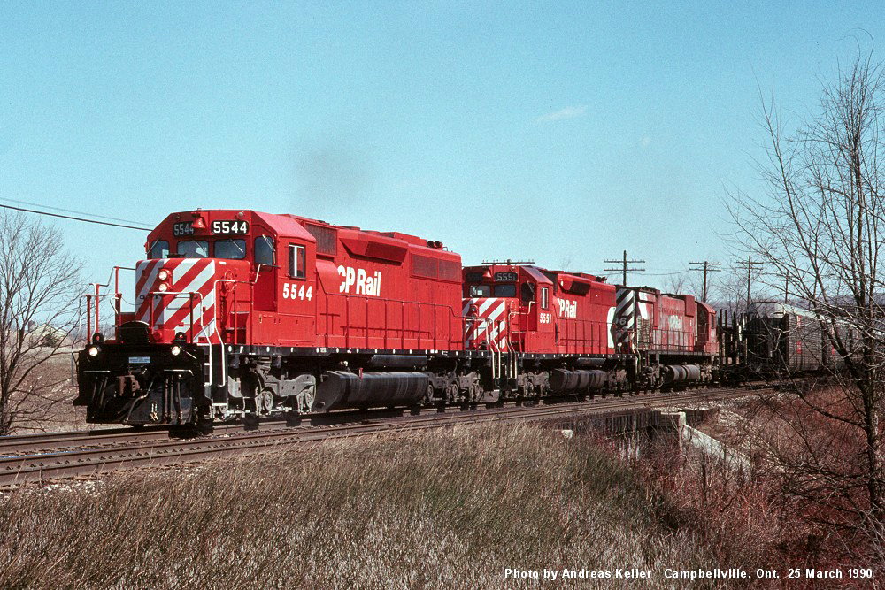 Canadian Pacific EMD SD40's 5544 - 5551, and MLW M636 4706, slug a westbound up the grade east of Guelph Junction