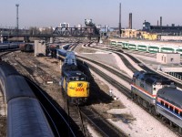Amtrak 352 is outbound from Toronto Union Station on March 28, 1984. She is about to pass VIA 6790 and her train which are being towed backwards.