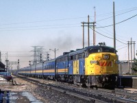 VIA 6764 is accelerating at the VIA station in Burlington, Ontario on March 26, 1984.