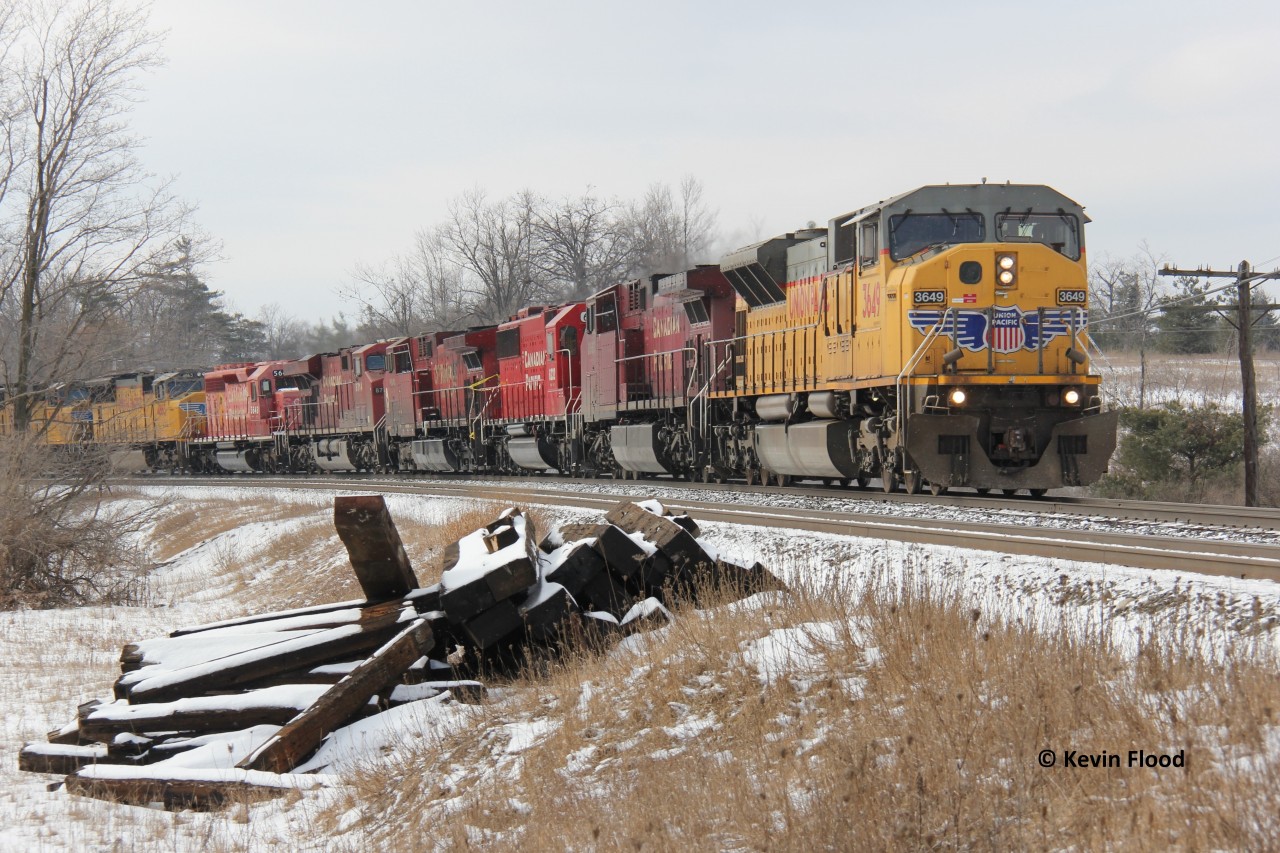 If I recall correctly, this train was CP 550, crude oil loads. It was definitely worth the chase from Orrs Lake to Campbellville. During the winter of 2015, the UP 90MACs frequented the area for a short period of time, so you bet I went out the door for this one! I think these engines have either been retired, scrapped, or some rebuilt. I believe a few were rebuilt into the new CP SD70ACUs, numbers 7058 and 7059, but not 100% sure. Also note the damaged locomotive and the ex-StL&H engine, followed by two more UP engines!