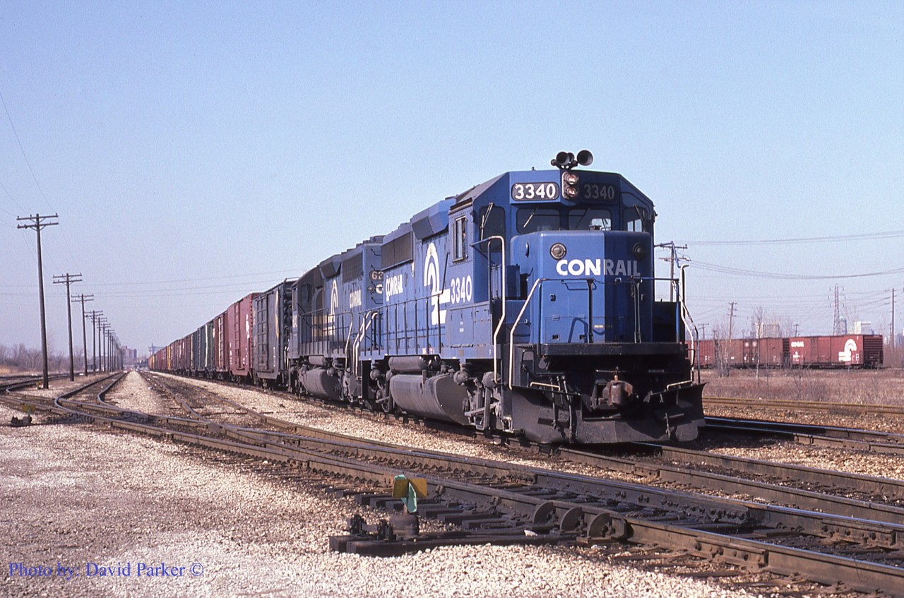 End of the line. Conrail ELDW-6 (Elkhart IN-Detroit/Windsor) with GP40-2 3340 and SD40-2 6442 stops at the South end of Track 5 in the Electric Yard, named so due to being in 3rd Rail electrified territory during the steam era. The American crew will then cut off and return light engines back to West Detroit.  The Electric Yard was numbered tracks 1, 3, 5, 7 and Short 9 (Switching lead) on the East side of the pole line. Tracks 2, 4, 6, 8 and 10 were on the West side although only tracks 2 and 10 remain at this time. The cars in the distance on the right are in the CR-CP Interchange tracks. Taken Feb 27th 1985 just two months before CN-CP will take over the Conrail trackage (CASO) in Southern Ontario.