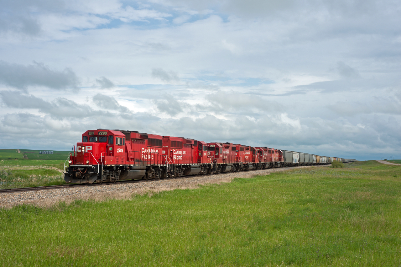 Grain loads from Prairie West Terminal (mile 82.1 Kerrobert Sub) are seen near mile 43 of the Macklin Sub with a six-pack of four axle units up front.