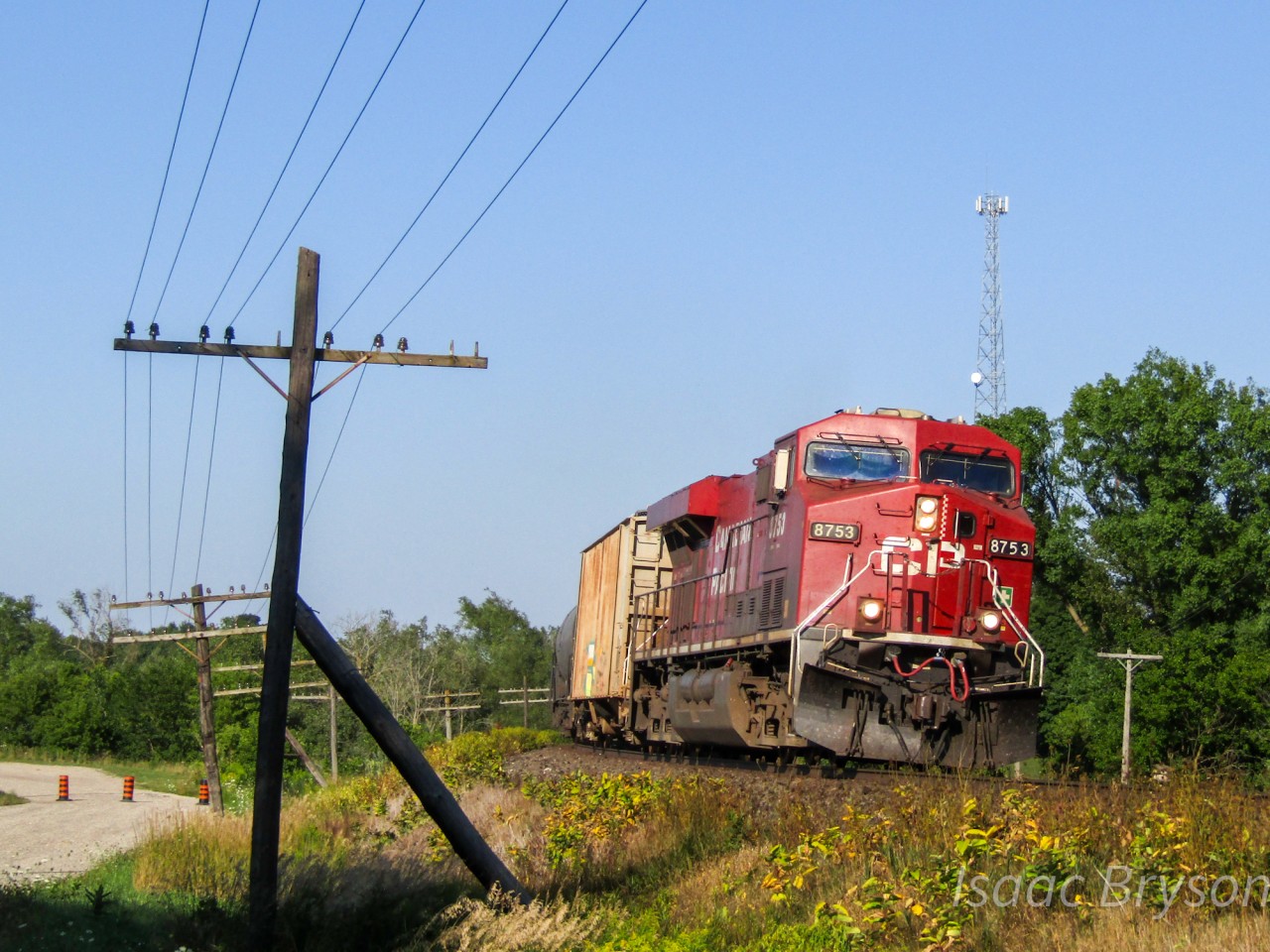 CP 651 flies westbound through Innerkip Ontario with CP 8753 leading the way. Exactly 4 1/2 days after catching 650 eastbound with the same power, 651 returns just 10 minutes after the sun hid behind a large pine tree, casting shadows on the telegraph pole.