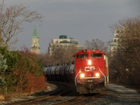 Rolling west along the CP North Toronto sub, CP 7041 pulls CP 651 and a little extra manifest, about 25 cars, before CP 7009 shows (pushing on the tail). In the background is the C.P.R. North Toronto clock tower and station. Built in 1916, the station has not seen revenue service in 90 years, and no passengers at all in 75. 