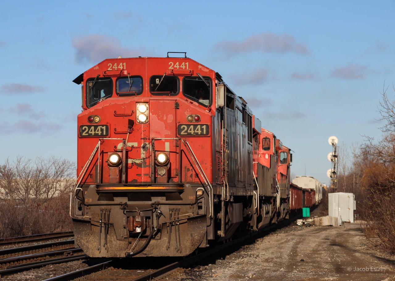 CN L570 with 2441 in the lead passes through Goreway Avenue with a ES44AC and a C44-9 trailing facing rear