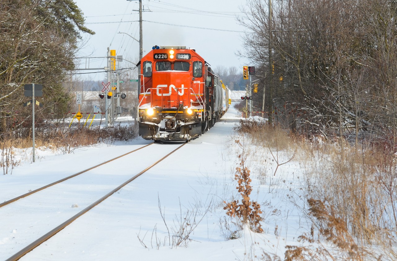 An unusual Sunday brings both of Kitchener’s power sets being separated. 540 took the GMTX set to Guelph leaving 568 with the CN set to make their movement to Stratford and HCL with a D6 from Babcock and Wilcox for Bruce Power near Goderich. A quick heads up that they’re ready to leave Kitchener with the GTW 6226 up front made me quickly run out the door and beat them to a spot I know I wouldn’t miss them at which brings this. The sun is out partially and the ground is snowy giving a perfect photo combo for the GTW 6226 and CN 4028 as they pull over the large intersection at Foundry St and Snyder’s Rd in Baden with a clear signal and the generator on the tail end. It’s decently hard to see anything out of Kitchener that isn’t with a blue GMTX leaser but it could very well happen at any time depending on what’s needed and that’s what peaks my interest. The high headlight on this former DT&I unit was also a neat change to your usual Guelph Sub power.