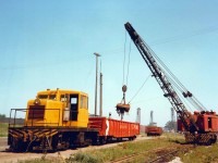 All is good in the world, Gondolas of Victoria Pig iron are loaded by American Rail Crane (blt. 1957) and shuttled around by the unnumbered GE Center Cab (blt. 1949) at the Canadian Furnace Division of the Algoma Steel Corporation.  The Blast Furnace situated on the east bank of the Welland Canal had an extensive rail network to move around metallurgical coke and other raw materials used in the Iron Making process, slag pots for dumping molten slag, and gondolas for shipping out the finished product.  Welland Canal Lift Bridges #21 (autos/trucks) and #20 (rail - ex CNR Dunnville Sub) can be seen in the distance.  Given that the Gons are CPR, the shipments would have likely been picked by the TH&B which retained running rights into Port up to the end of 1988.  The scene looks very different today with all the rails gone, Bridge #20 gone since 1997, and much of the property used for raw material bulk storage (Salt, Sand, Calcium Sulphate-Gypsum, etc) offloaded by lake ships. As a side note, there is growing interest in Pig Iron to help offset the rising prices of Scrap used in EAF - Electric Arc Furnace steelmaking with STELCO Nanticoke commissioning their new Pig Casting machine in Q1 2021.  