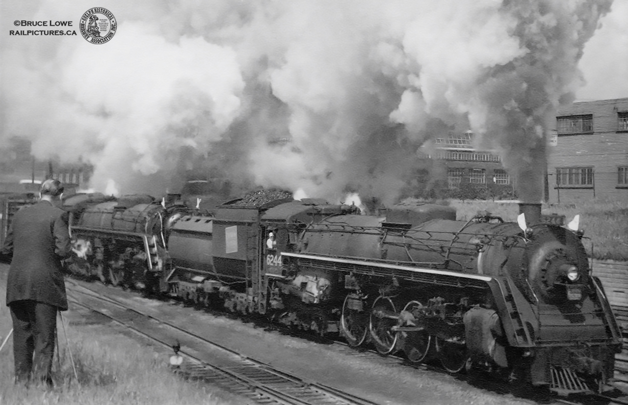 Now who could that be?  It’s amazing what can be stumbled upon when researching historical photos.  With only a date and location for this image, it seemed as though the identity of the photographer at left would be lost to time, though it turns out his images are well preserved too.  Researching the Toronto Suburban Railway led to the Toronto Public Library Archives section “Railroad yards--Ontario—Toronto” where I came across this image…  Pretty similar, taken a bit further left.  It seems this was James Victor Salmon, born in 1911, who was a well-established Toronto photographer, historian, and a designer for the Toronto Hydro Electric System for thirty years.  His collection of Toronto photography contains over 15,000 images and culminated in his writing of Rails to the Junction: The Story of the Toronto Suburban Railway, which, after his death in 1958 at the age of 47, would be posthumously published by his wife, Jean, in 1970.  Much of his work can be found on this Urban Toronto page and through the Toronto Public Libraries archives.Here, Bruce captures James alongside CNR 6244, a U-2-h 4-8-4 Confederation type, the tenth built in an order of 30 (6235 – 6264) by Montreal Locomotive Works in September, 1943.  It would be scrapped in April, 1960.  Note the difference in appearance of this U-2-h locomotive to other classes of CNR Northerns in the lack or relocation of the Elesco feedwater heater from just ahead of the smokestack.  The double headed eastbound freight is seen approaching the Strachan Avenue underpass on the Oakville Sub.  In the background at right is the John Inglis plant.From it’s beginning in 1859, John Inglis and Company has gone through many changes.  Founded by Thomas Mair, John Inglis, and Francis Evatt on July 27, 1859, the company began as small machine shop under the name Mair, Inglis, and Evatt in Guelph producing milling machinery before moving to the Strachan Avenue location in Toronto in 1881 becoming John Inglis and Sons.  The company went through multiple name changes to the John Inglis Company Limited in 1913, John Inglis and Company in 1937, Inglis Limited in 1973 and finally Whirlpool Canada in 2001.  The famous blue and white billboard overlooking the Gardiner Expressway would go up in 1975 with many messages displayed to motorists over the years.  After discontinuing milling equipment in 1903 the company shifted to the industrial market making stationary and marine steam engines, pump house engines, shells for use by allied troops during WWI, turbines, and weaponry and munitions used in WWII, before moving to consumer products.  These included fishing tackle, house trailers, heaters and stoves, wringer washers, and later fully automatic ones, electric and gas driers and dishwashers.  Inglis would launch it’s Whirlpool brand of washers after selling it’s 1 millionth automatic washer in 1972.  As the company slowly moved operations to Mississauga beginning in 1981, the Toronto location was sold off piece by piece.  By the early to mid 2000’s, gentrification and condo development had begun.  The final piece of Inglis, the billboard, would be dimmed and demolished during the last week of July, 2014.More CNR 6244:Bill Thomson: Freshly stored at Mimico, 1959Don Ross: Cold and dead at Mimico, Dec. 1959The old Inglis Sign: March, 2004.A series of Salmon’s images taken at Strachan avenue in 1955 from the Toronto Railway Historical Association: Railfanning Liberty Village in 1955.