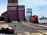 I do not have many photos that show the doors open on the elevators, as well as able to see right through, as in this case. This is also one of the few pictures where I included the Redwater section shack in the photo. 584 is lead today by the 1077, 1069 and 1078, with cab 79836 bringing up the rear. The marks of unloading molten sulphur tanks in the early 80's into tank trucks is still very evident. The elevator track would have a number of tanks spotted for offloading on occasion. By 1983/84 this came to an end and the only sulphur traffic that remained was the bright yellow chips in the open hoppers passing by from Fort McMurray. 
