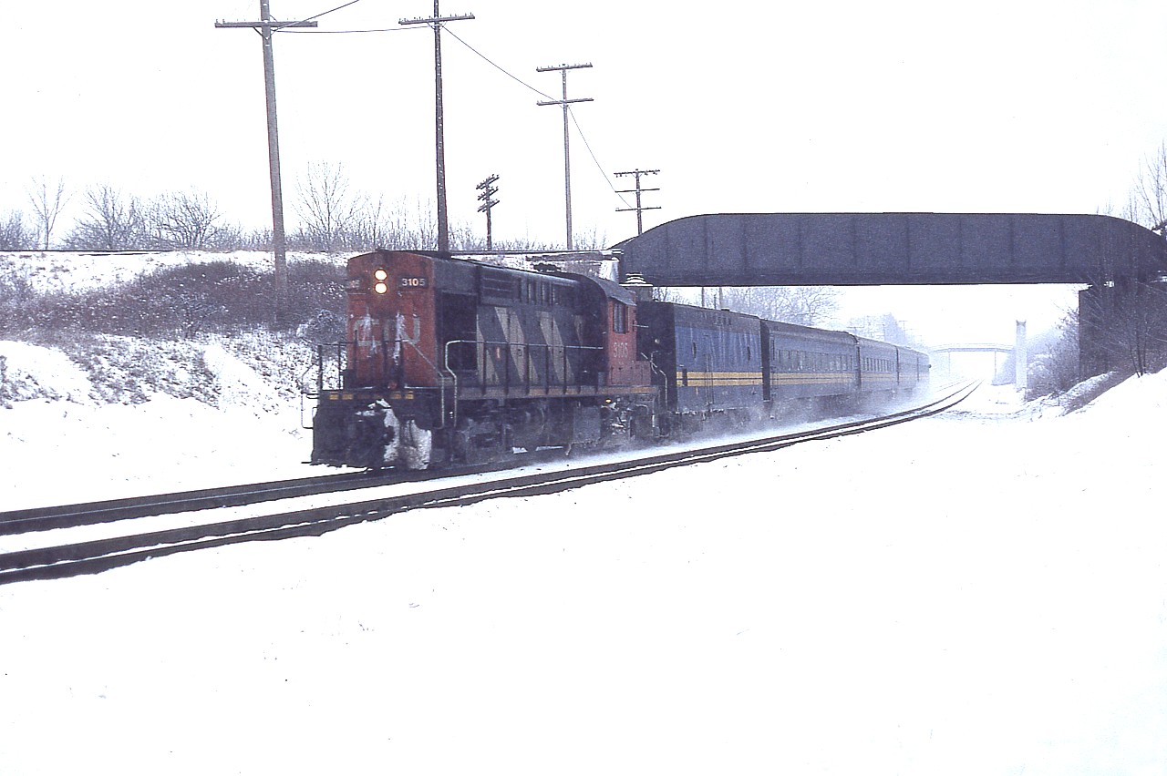 Merry Christmas to all members and lurkers on RP!!

At least in celebration of the holiday I came up with a photo with appropriate snow in it. :o) This late January shot was taken looking west at the CP overpass about 3/4 mile from Bayview. Back when the world was sane I could park at the Junction and walk. It was comforting because you never knew what was coming at you. In the days before ATCS and all that other stuff that takes away the guesswork, anticipation used to be the highlight of train watching. Now, it is catching in the right spot what you know is on the way. There is a huge difference.

So I am wandering along kicking snow, I guess, and I hear this one on approach. Thus resulting in this image of CN (VIA) 3105, a shot I found interesting because I had totally forgotten that Old Guelph Rd bridge was replaced in the winter of 1981-82. You can see the posts behind the CP bridge. And, of course, in the distance is that walk bridge that is still used by the train watchers today, if they can find a place to legally park.

Here's to 2021. (I think!)