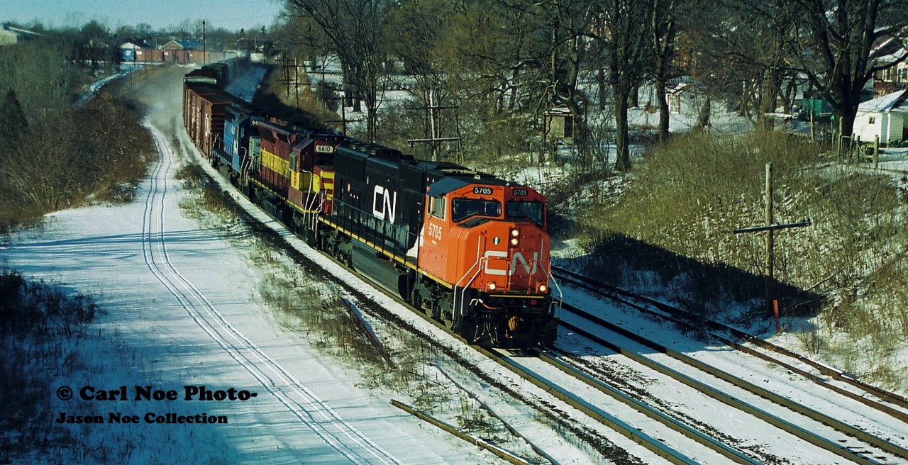 A CN eastbound curves through Paris, Ontario with newly built CN 5705, WC 6610 and Electro-Motive Leasing 6410 on the last day of 1996.