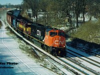 A CN eastbound curves through Paris, Ontario with newly built CN 5705, WC 6610 and Electro-Motive Leasing 6410 on the last day of 1996. 