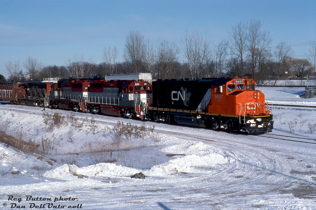 CN GP40-2W 9657 (in the snappy CN North America livery) leads EMDX GP40-3's 200 & 201 and a ratty zebra striped CN 9653 on train #333, seen at Aldershot on a cold February day in 1994. The two EMD lease units are former GO Transit GP40-2 units 725 and 726, and have recently joined the EMD lease fleet (they were originally built as GP40's (non-Dash 2) for the Rock Island, before becoming GO commuter units via Chrome Crankshaft after "The Rock" went bankrupt).As more F59's joined the roster in the late 80's and early 90's, GO's older "40-series" units were either sold off or leased out. Eventually GO 720-726, after doing time leased out to CN and CP (at least two even made it out to Alberta), were used as trade-in credit to EMD for GO's final order of F59PH's (562-568) built in early 1994. EMD didn't waste time repainting the Geeps in their maroon, silver and grey paint livery, renumbering them into the 200-series, re-equipping them with dynamic brakes, and leasing them out in freight service.Reg Button photo, Dan Dell'Unto collection slide.