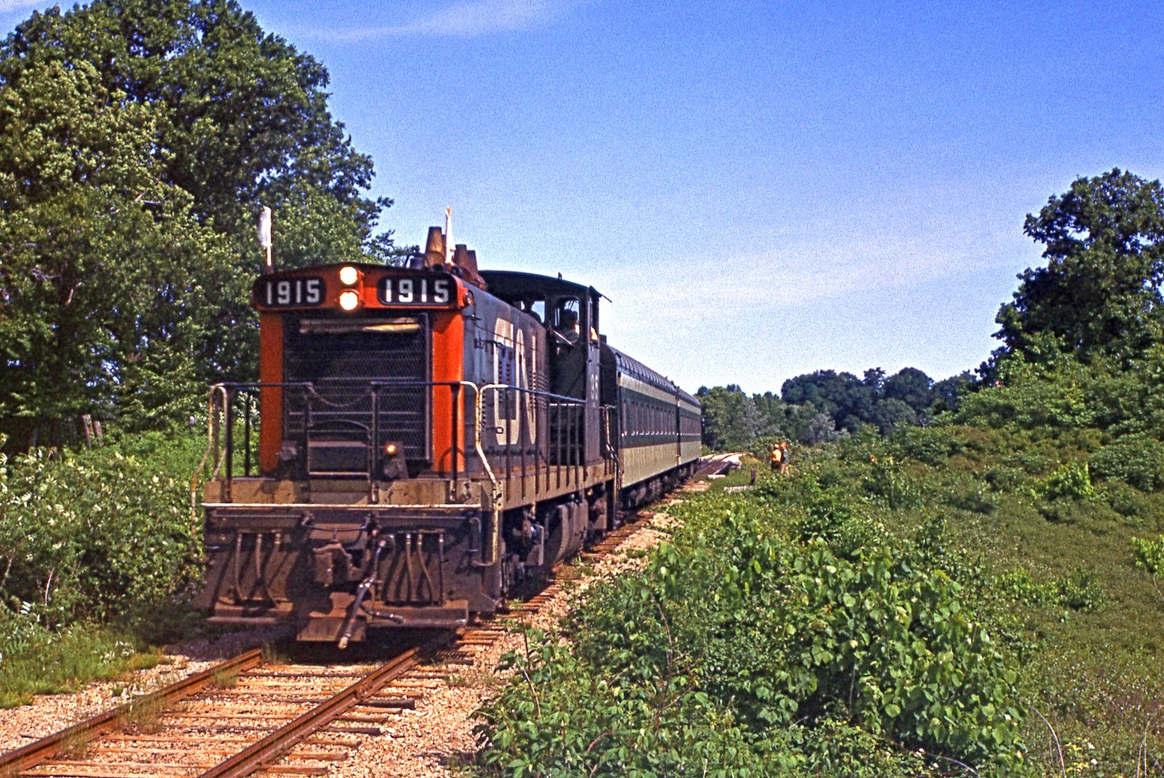 An FCRS (Forest City Railway Society) excursion in June 1970 featured CN GMD1 1915 as seen here on a run-by at Yarmouth on the old L&PS line.