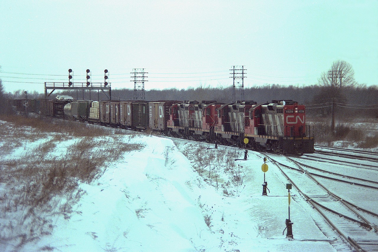 Geez........one of those blustery cold days deep in the bowels of winter. Groundhog Day, actually. In this rather frosty view, CN GPs 4576, 4579, 4563 and 4525 have just passed CN Duff and are bringing their train into the west end of Fort Erie yard.  I have no information on this mixed freight other than if I recall correctly all those GPs were based here.