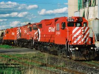 On a warm spring evening, the CP Hamilton Turn (525) is viewed lifting a cut of 12 hoppers at Ayr, Ontario on the Galt Subdivision. Powering the job are 3104, 4207 and 8240, which will soon depart westbound to London with 26 cars and for a meet with 516 at Blandford. My notes showed 516 later passing through Ayr with 5565, HLCX 6203, 4248, 5643, GATX 903 and 5612.  
