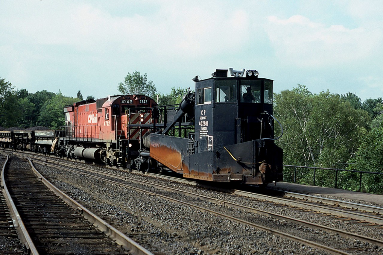 Was at the Parry Sound CP station on a rather hot afternoon for a spell; all quiet. Waiting a work train coming up from MacTier. Here it is rounding the curve toward the station having just crossed the Parry Sound trestle. Do not recall where it was headed. CP 4742 the power, with an old (1960)Spreader leading, #402881. Rather tired looking thing. The Canadian Trackside Guide states this relic is still around, now assigned to Binghamton !