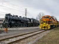 The Guelph Junction Railway, operated by the Goderich & Exeter railway passes by locomotive 6167 in her new spot at John Galt park. On November 14th 6167 was moved from her home by the Guelph Central Station to this location by the GJR. The move was necessary due to Metrolinx's plans to expand the station. Obviously the area is still under construction, as evidenced by the safety ribbons and pylons. Eventually there will be a nice pathway around the locomotive. 

<br> Interesting note, 6167 sits directly at the site of the Priory, the first building in Guelph. Built by Guelph founder John Galt. The Priory would also serve as the first post office, and when the CPR arrived in Guelph in the 1880s, it became the CPR station. The Priory was replaced by a stone station built around 1910. This area is a highly significant area to Guelph, and its railway history. A fitting spot for 6167.