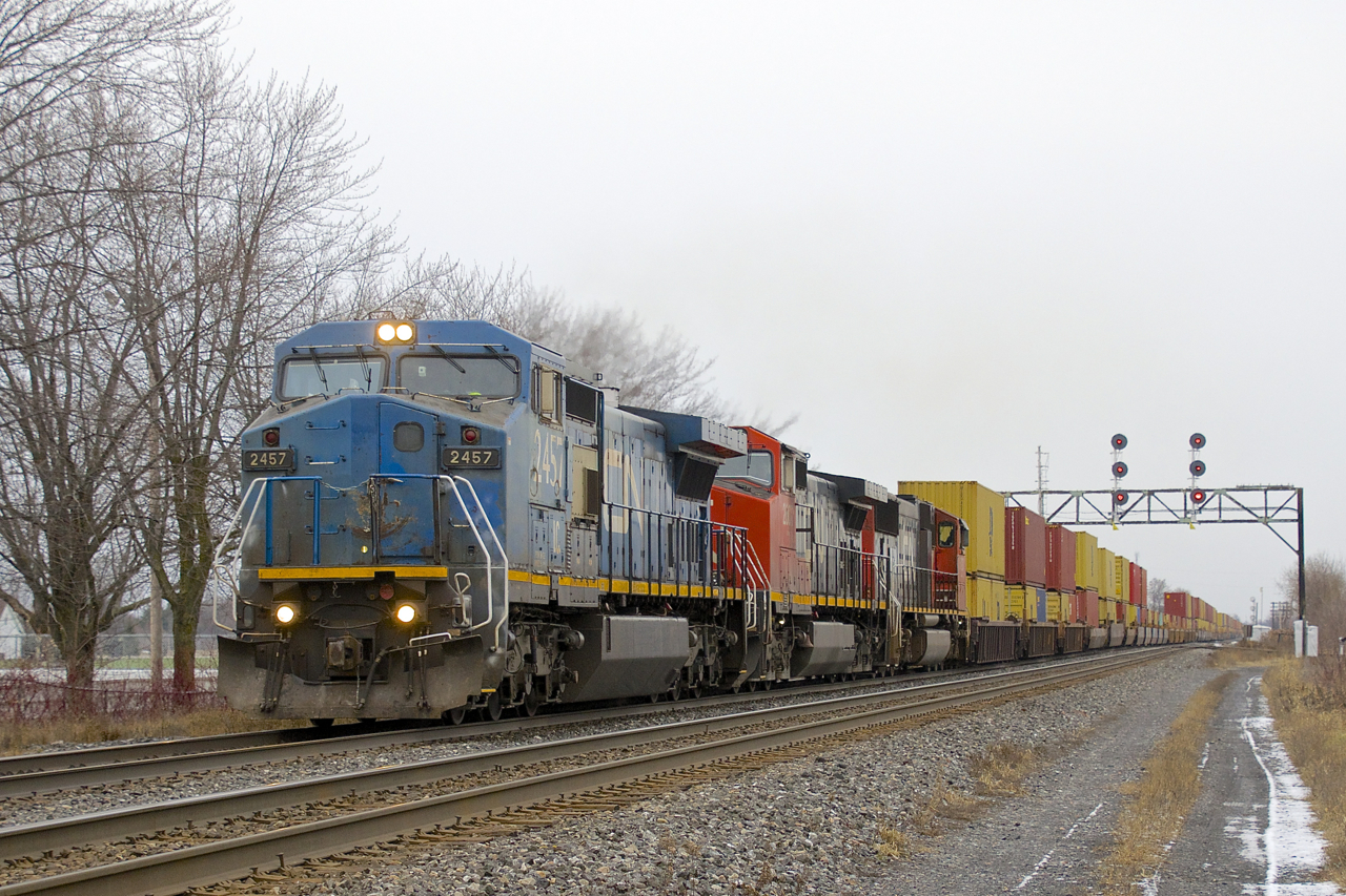 A late CN 149 is passing through Coteau with IC 2457, CN 2607, CN 5727 and a 574-axle long train.