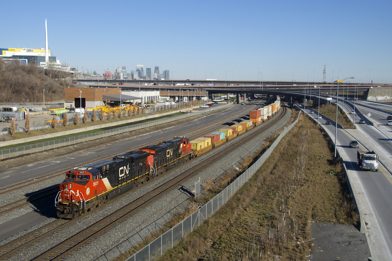 CN 3825 & CN 2932 lead a late CN 149 past the rebuilt Turcot interchange. Most of this area, including CN's current main line here was part of CN's Turcot Yard, which closed in 2002. In the upper far left you can see the McGill University Health Centre, located on what was the site of CP's Glen yard.