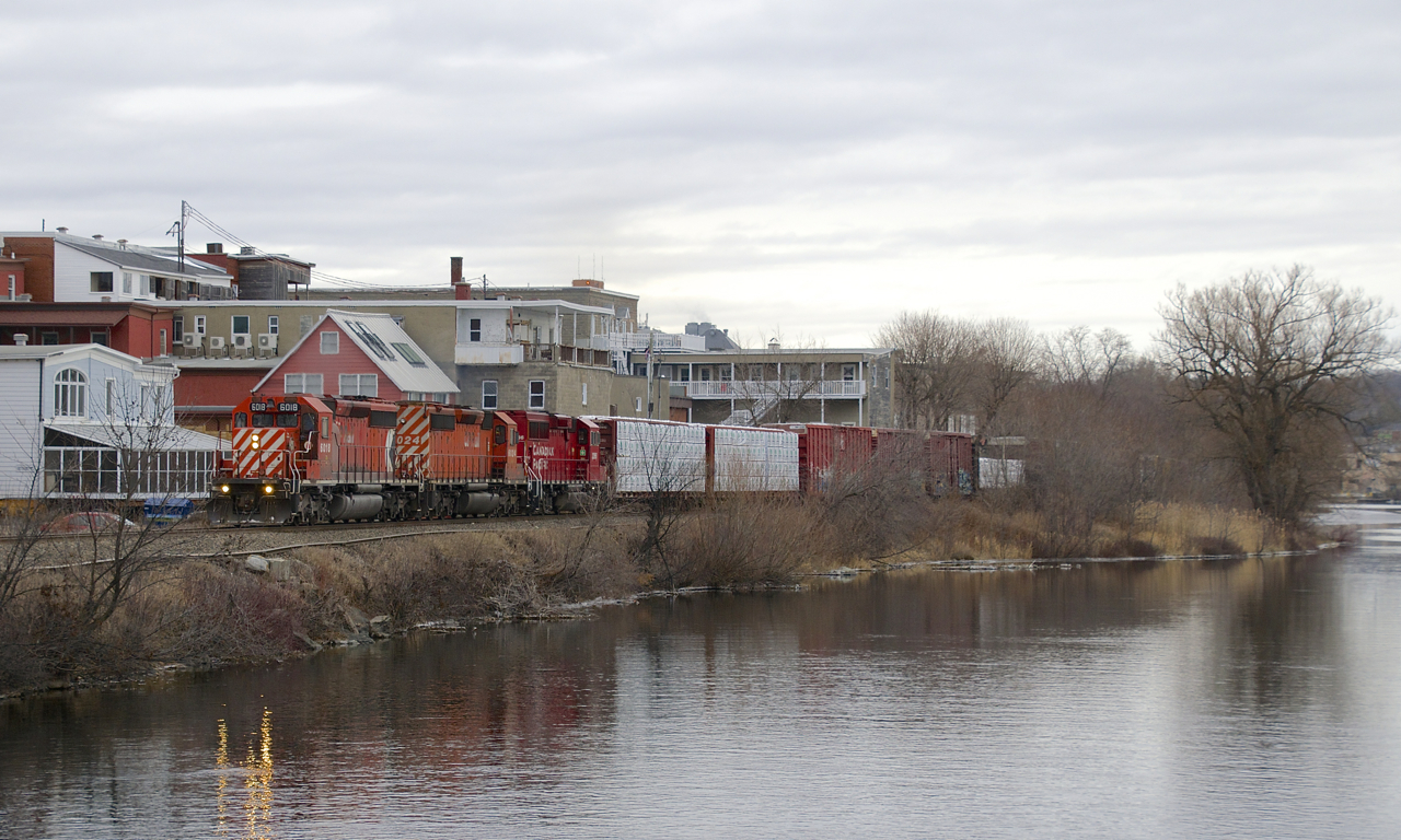 CP 251 is following the Magog River as it slices through the town of the same name with CP 6018, CP 6024, CP 2266 and a respectable 68 cars on an overcast morning. This pair of SD40-2's has now made three round trips from Montreal to Maine.